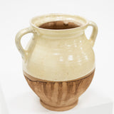 a cottage style cream and natural vase with two handles