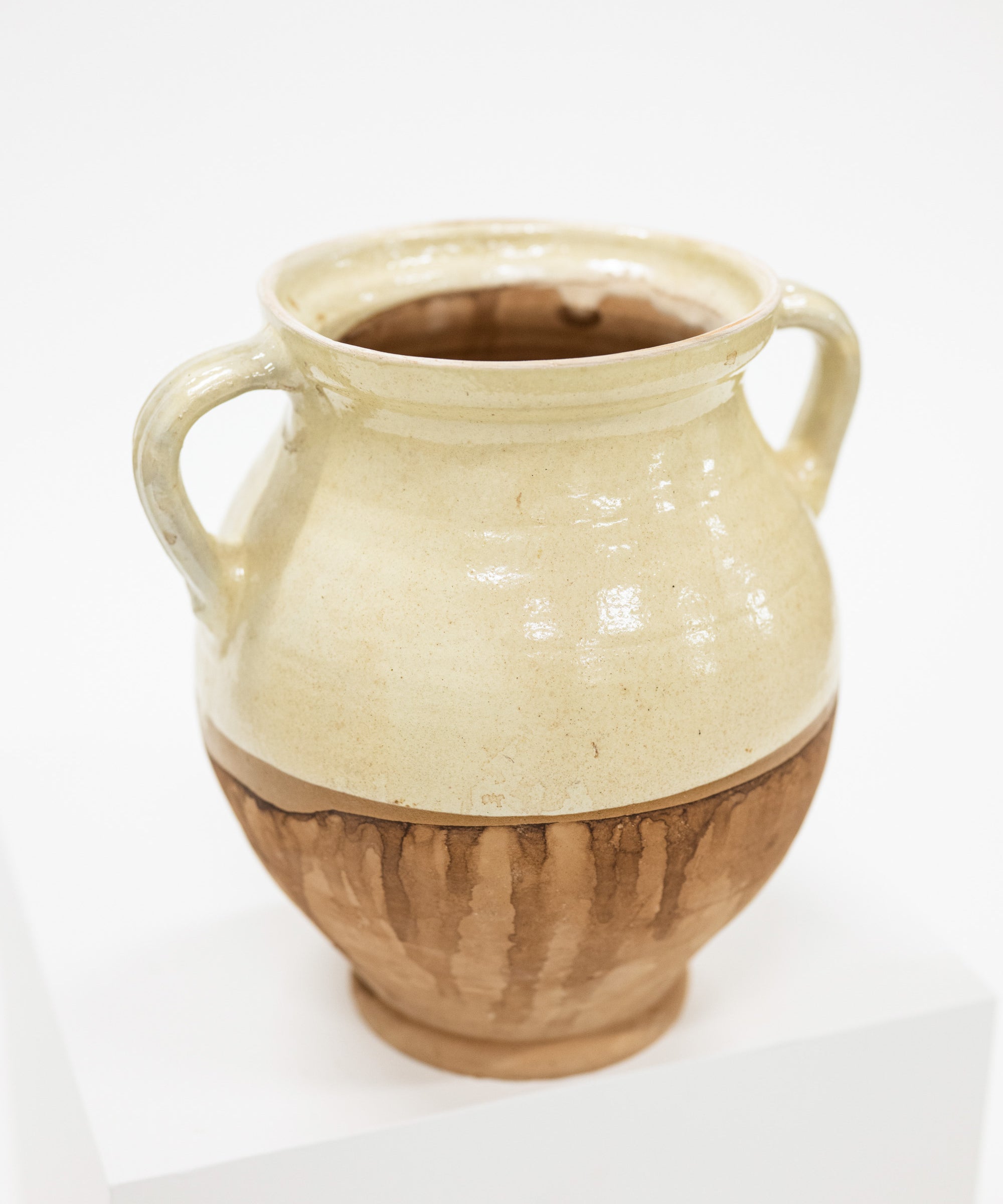 a cottage style cream and natural vase with two handles