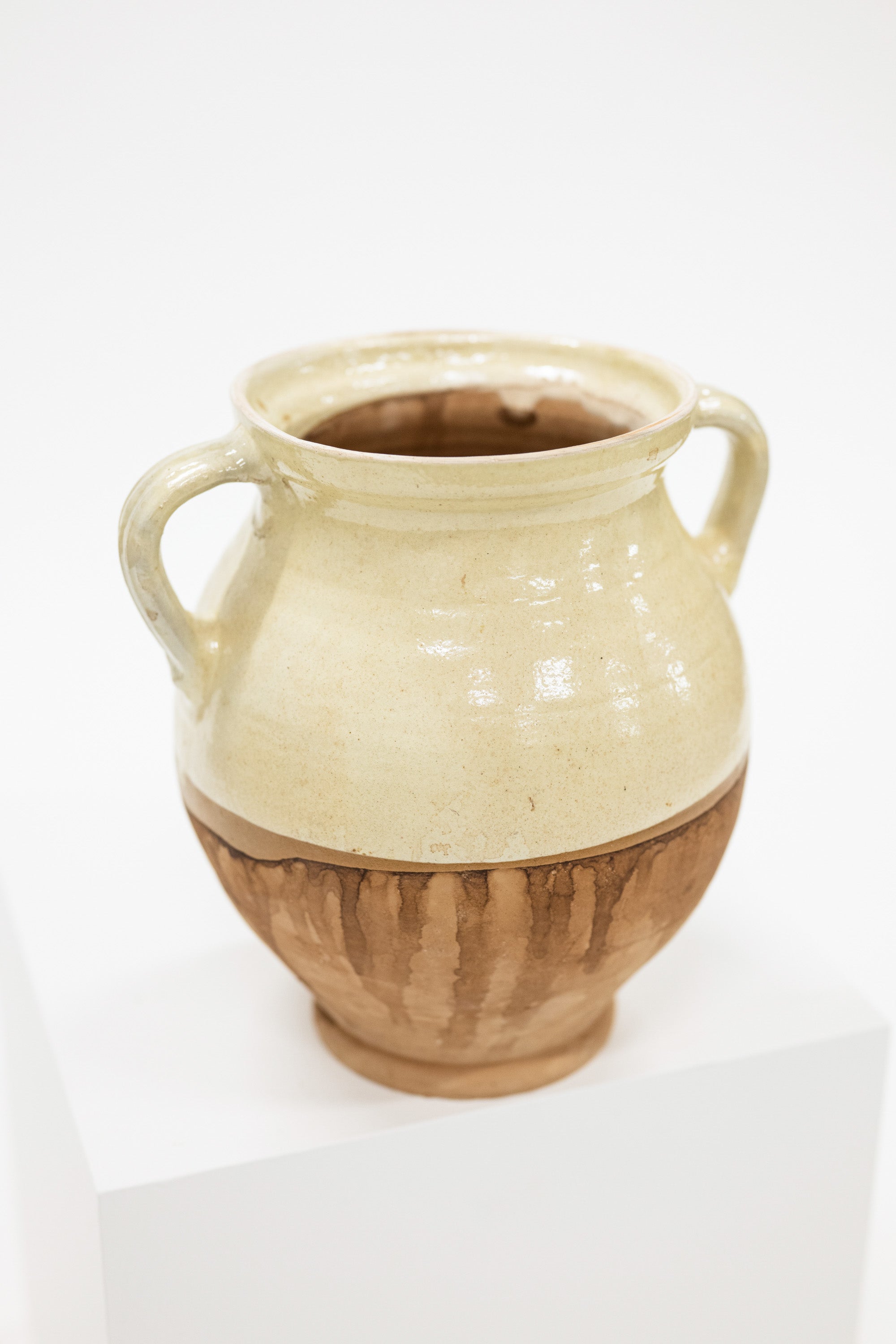 a cottage style cream and natural vase with two handles
