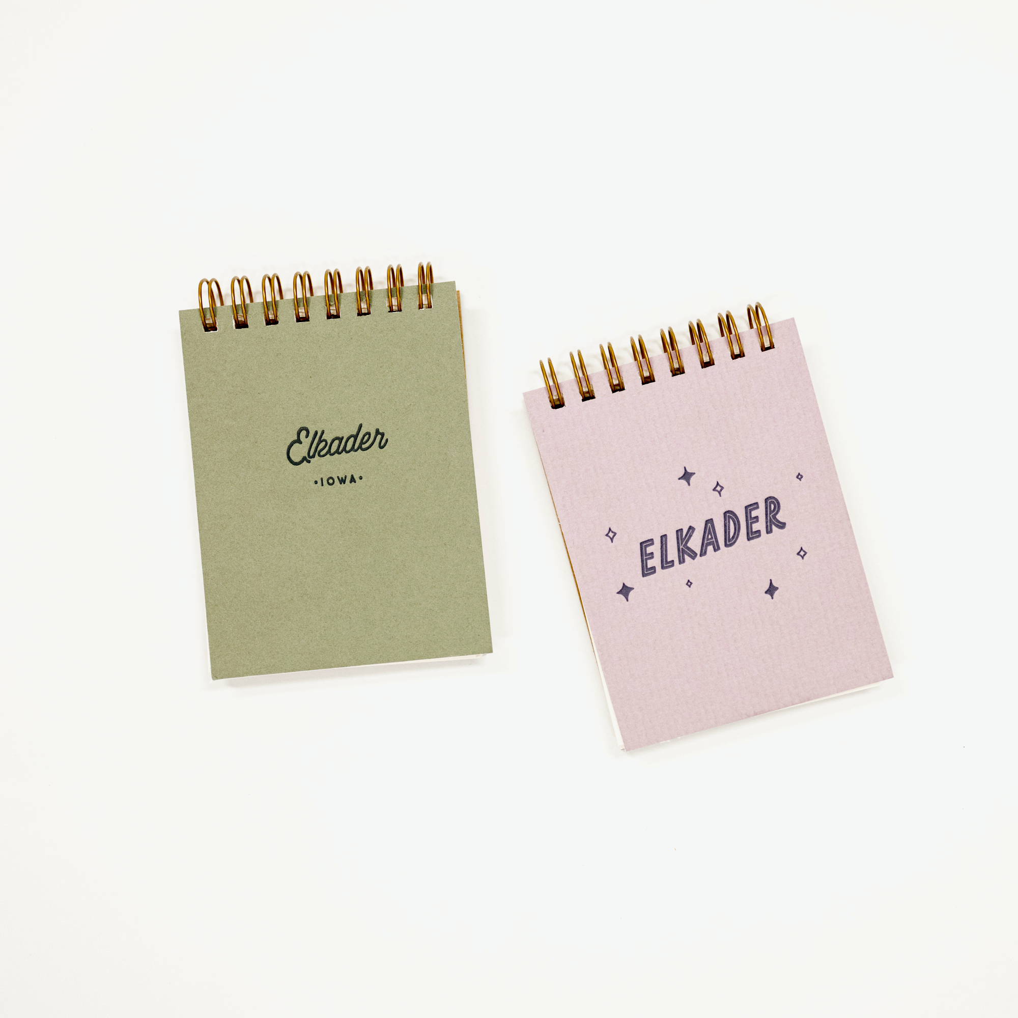 Pair of elkader labeled mini notebooks.