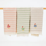 set of three kitchen towels with stripes and embroidered chickens. each chicken features a different sweater on the chicken