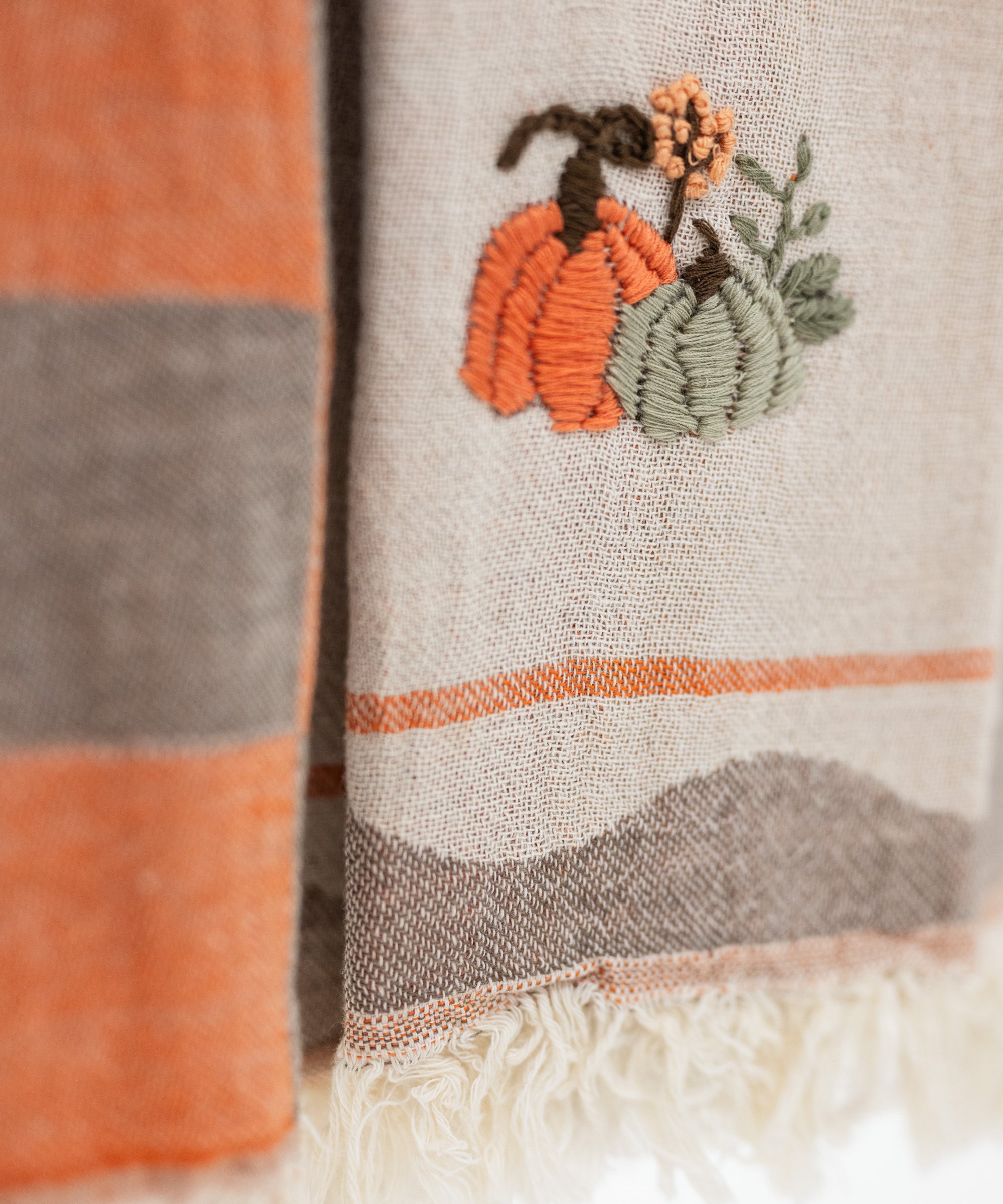 close up look at the embroidered pumpkins on turkish cotton kitchen towels