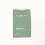 Noshinku Eucalyptus hand sanitizer dispenser in sage green, featuring white text and a small clear cap, shown on a plain white background.