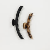 Black and bronze hair clips on a white background