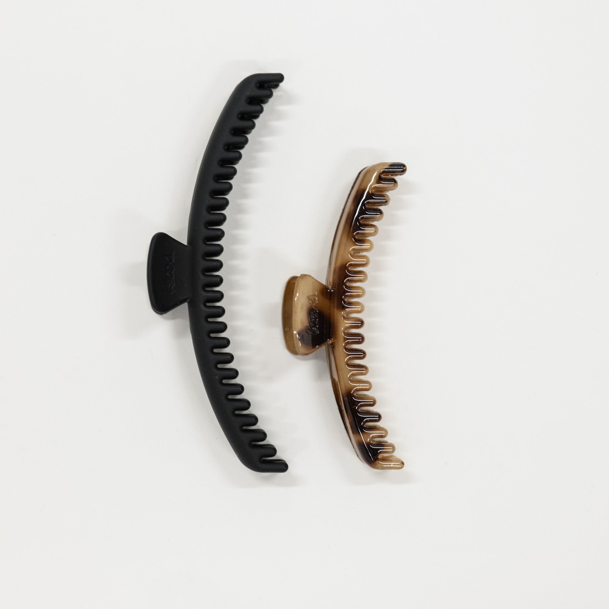 Black and bronze hair clips on a white background