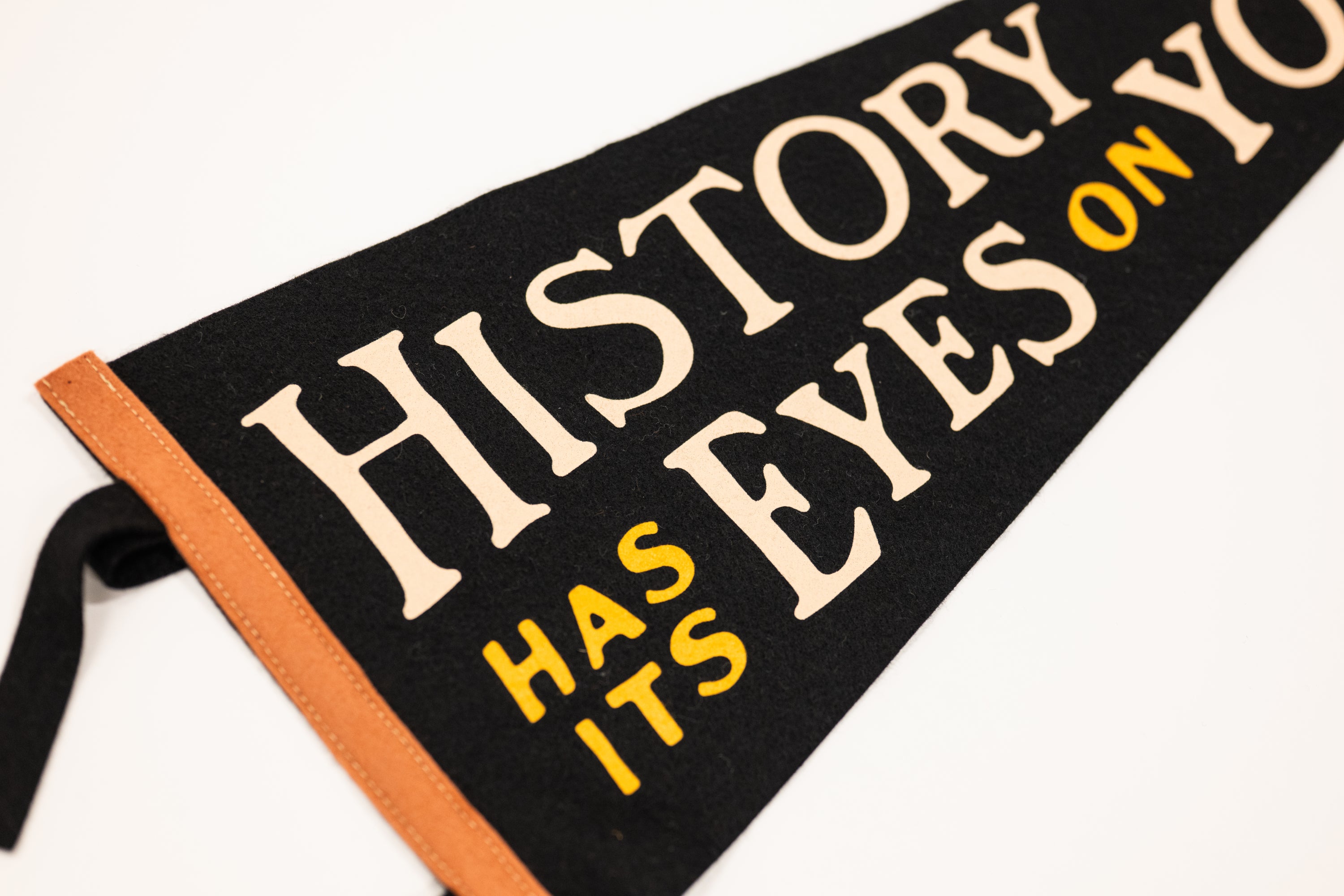 Book with text 'History has its eyes on you' on a white background