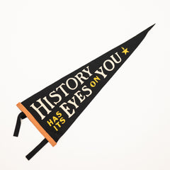 Black pennant with gold text and a star on a white background