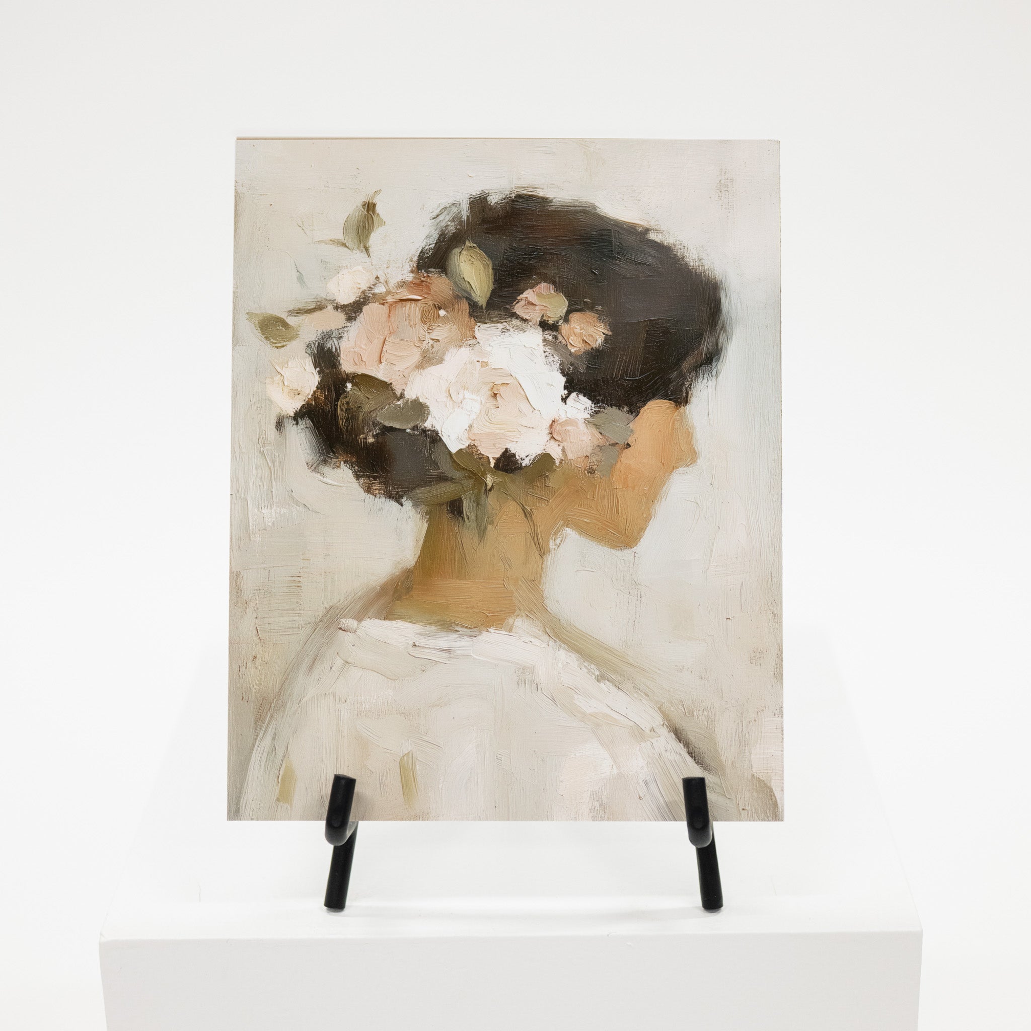 Artistic depiction of a woman with flowers on her head displayed on an easel.