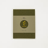 green flower press book with green and beige cover on a white background