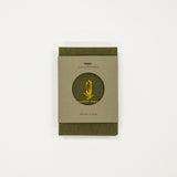 Green flower press book with a circular design and text on a white background