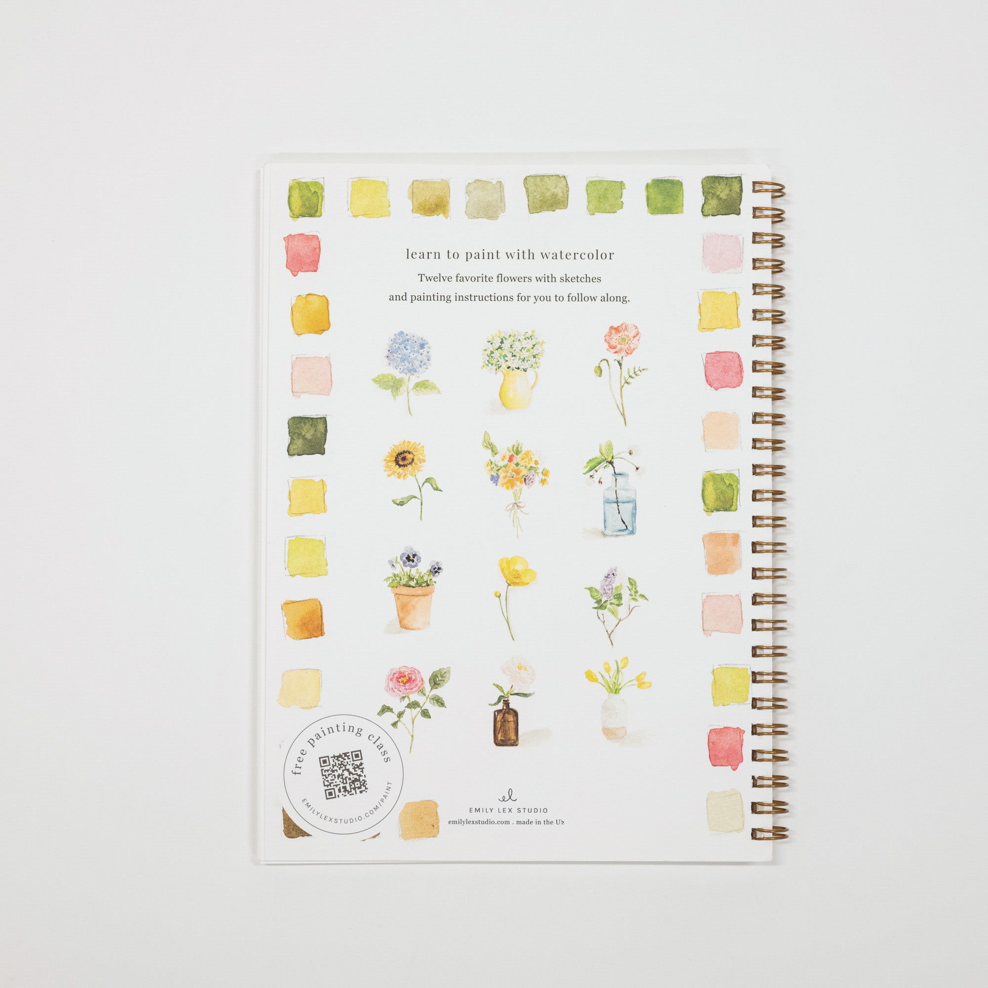 A spiral-bound notebook titled 'learn to paint with watercolor' by Origami Design, featuring a white cover decorated with watercolor flower illustrations and color swatches, shown on a light gray background.