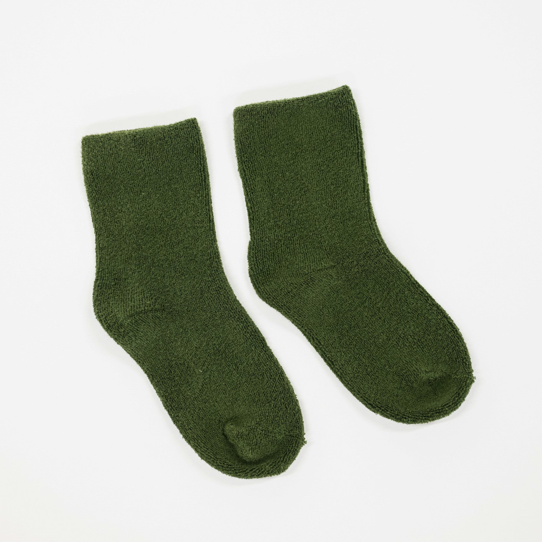A pair of dark olive green crew socks with a soft, fuzzy texture, displayed flat against a plain white background.