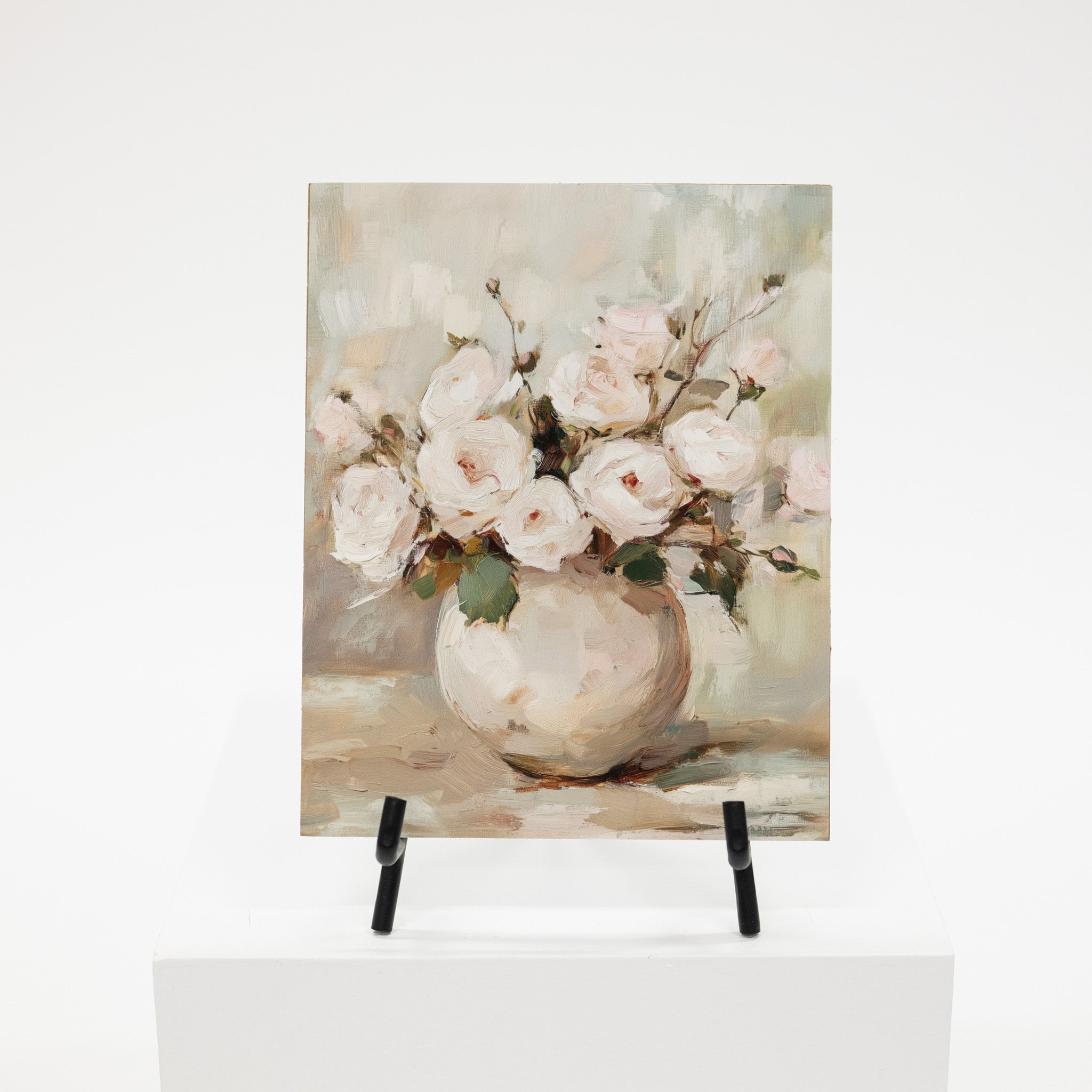 Art print of a floral arrangement in a vase on an easel with a light background