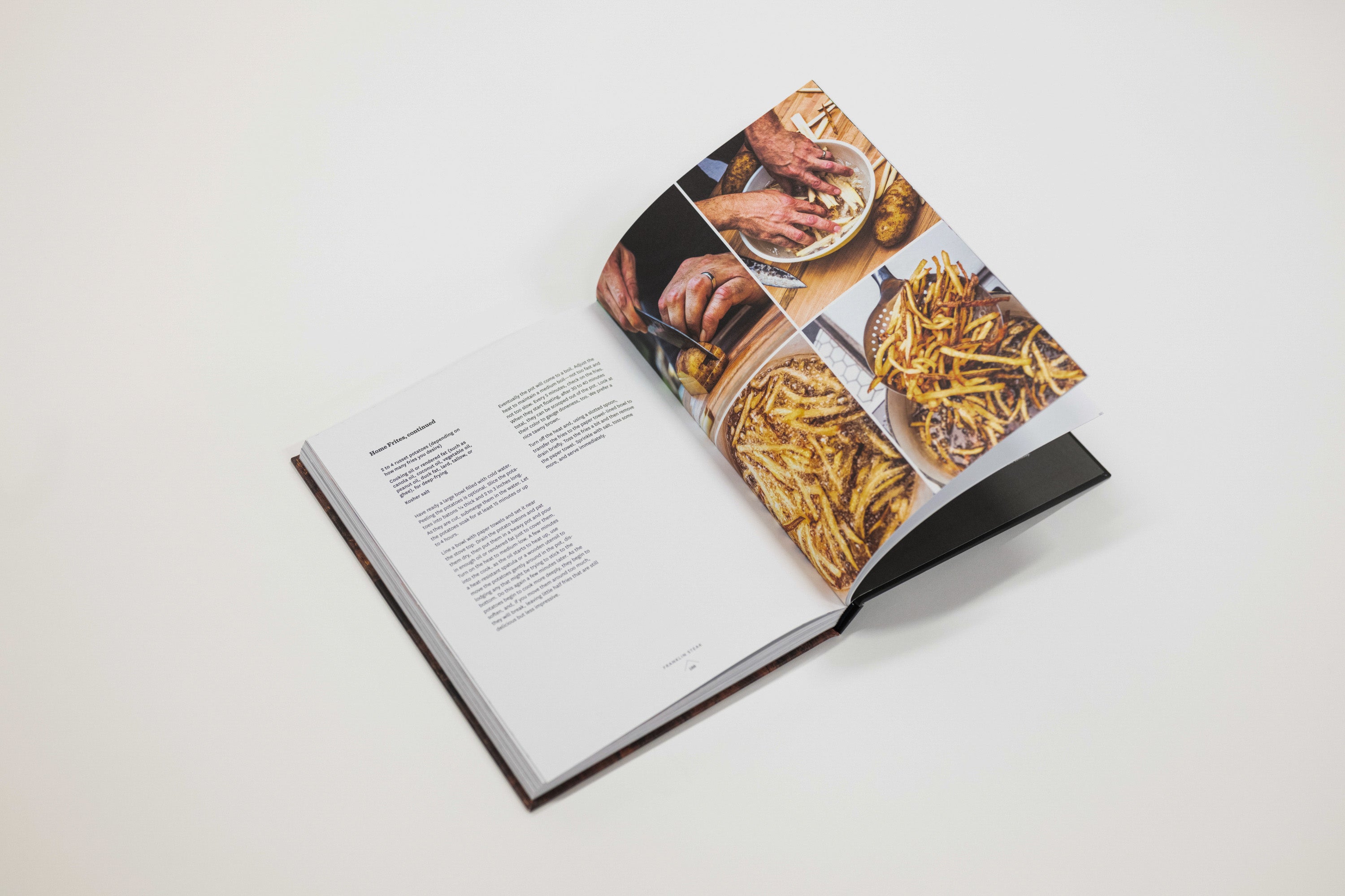 An open hardcover cookbook photographed on a clean white background. The right page features a collage of food photography, including hands preparing food and plated dishes, while the left page contains printed text.