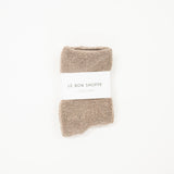 A collection of cloud socks in various colors, neatly arranged on a white surface, each with a label indicating the size range of 6-10.