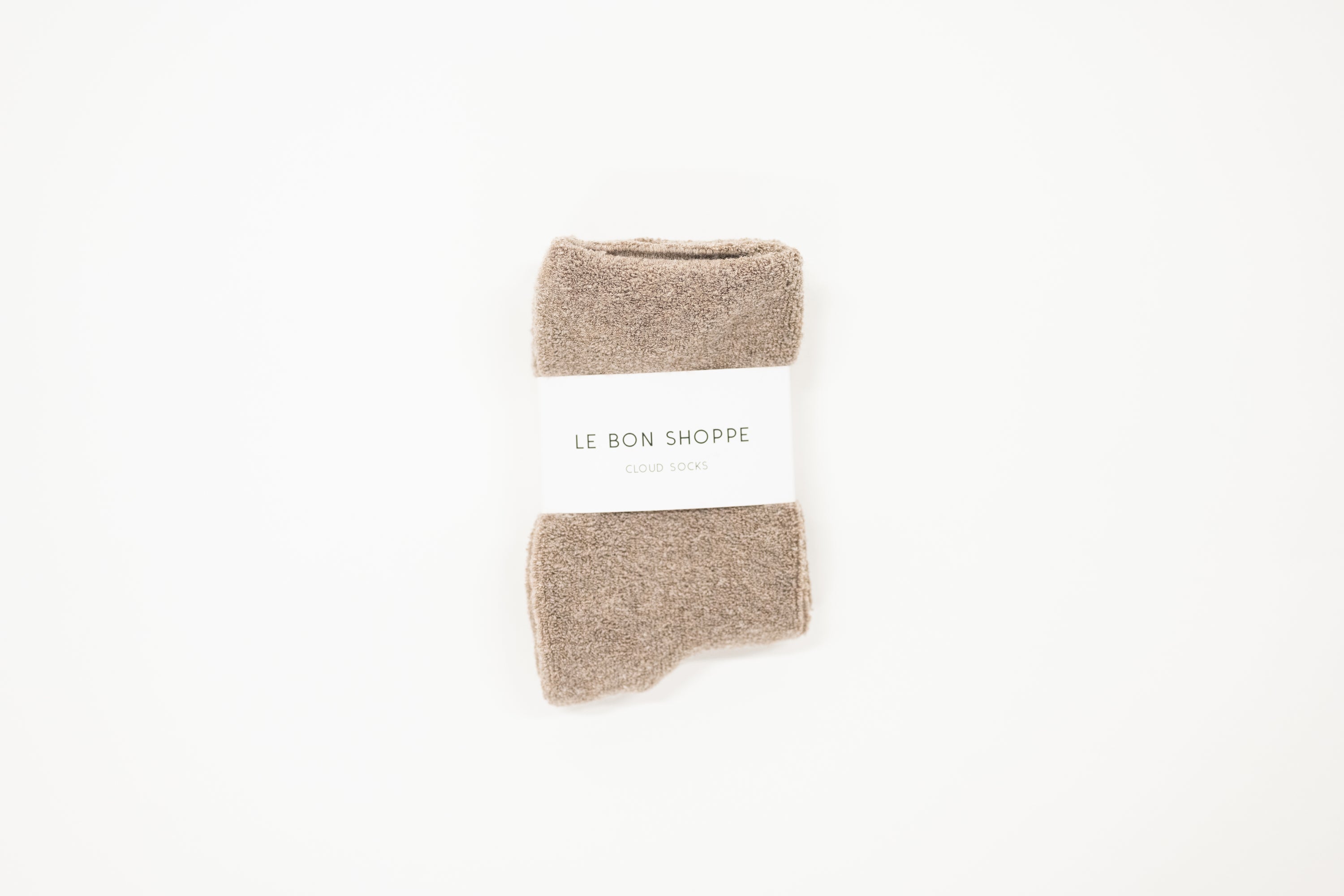 A collection of cloud socks in various colors, neatly arranged on a white surface, each with a label indicating the size range of 6-10.