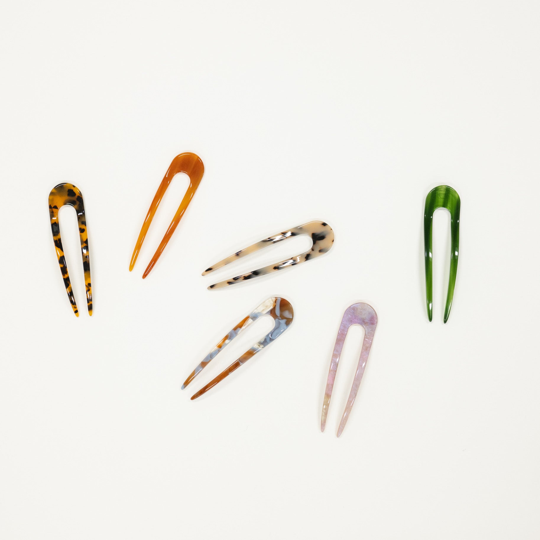 Set of colorful french hair pins on a white background