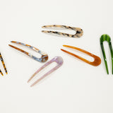 Set of colorful french hair pins on a white background
