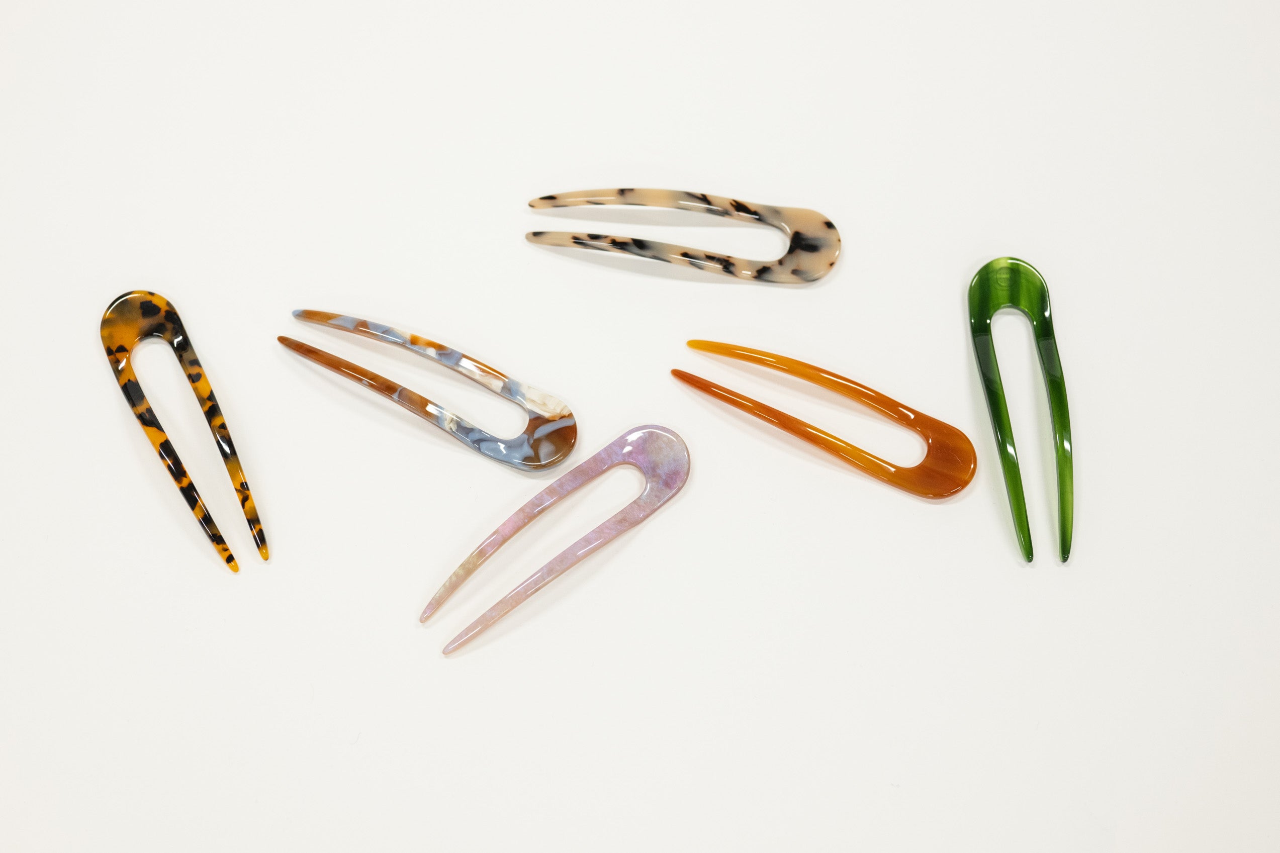 Set of colorful french hair pins on a white background
