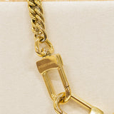 Gold chain with padlock on a beige background