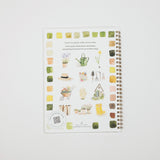 A spiral-bound watercolor painting guide book titled 'learns to paint with watercolor' by Erica Stevenson, featuring various watercolor garden illustrations and color swatches on a white cover, set against a light gray background.