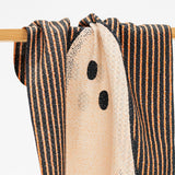 the top of a kitchen towel for fall with black and orange stripes and a ghost