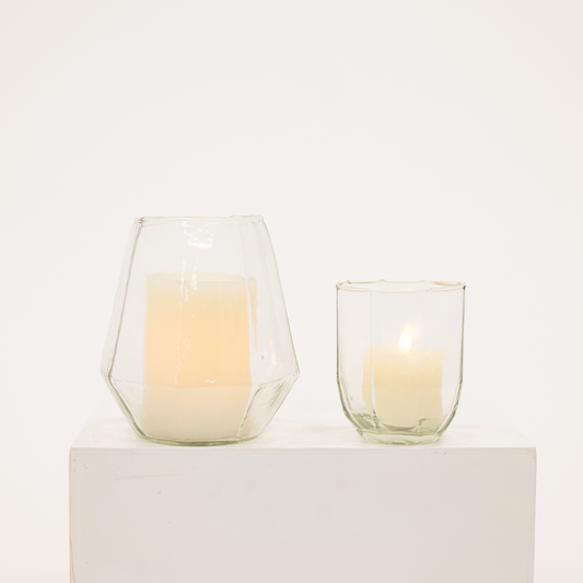 two glass candle hurricanes