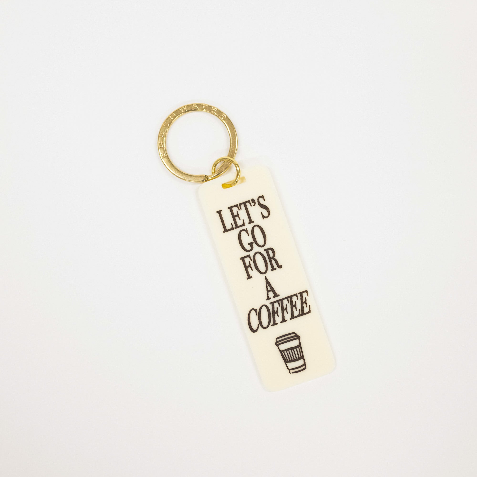 A rectangular cream-colored acrylic keychain with the text 'LET'S GO FOR A COFFEE' in black lettering and a small coffee cup graphic, attached to a gold split ring, shown on a plain white background.