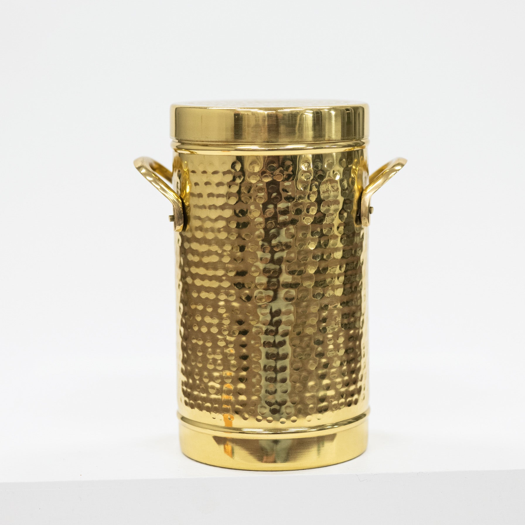 Gold textured ice bucket with handles on a white background