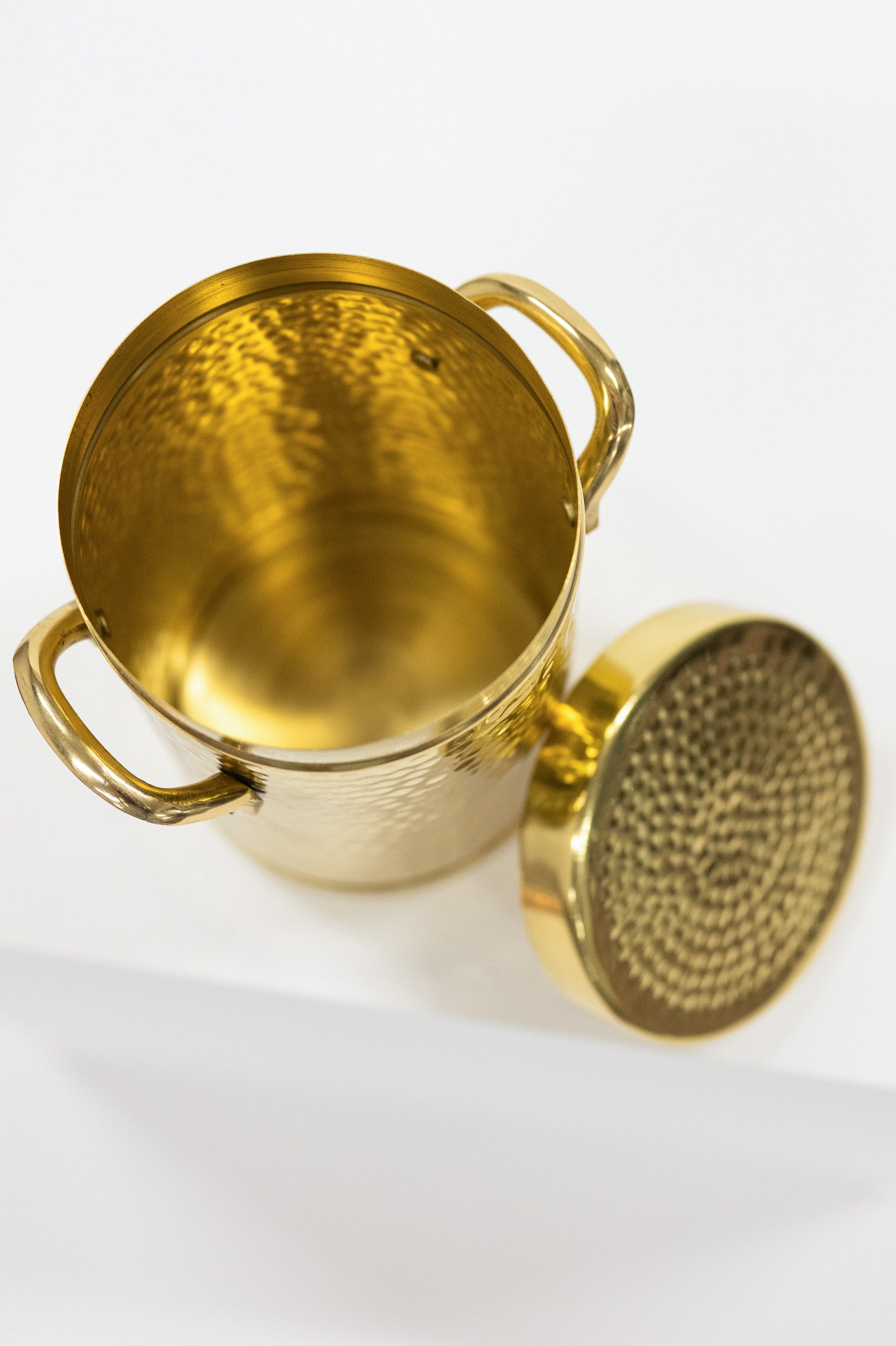 Gold metal canister with lid on a white background