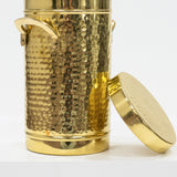 Gold metal container with textured surface and lid on a white background