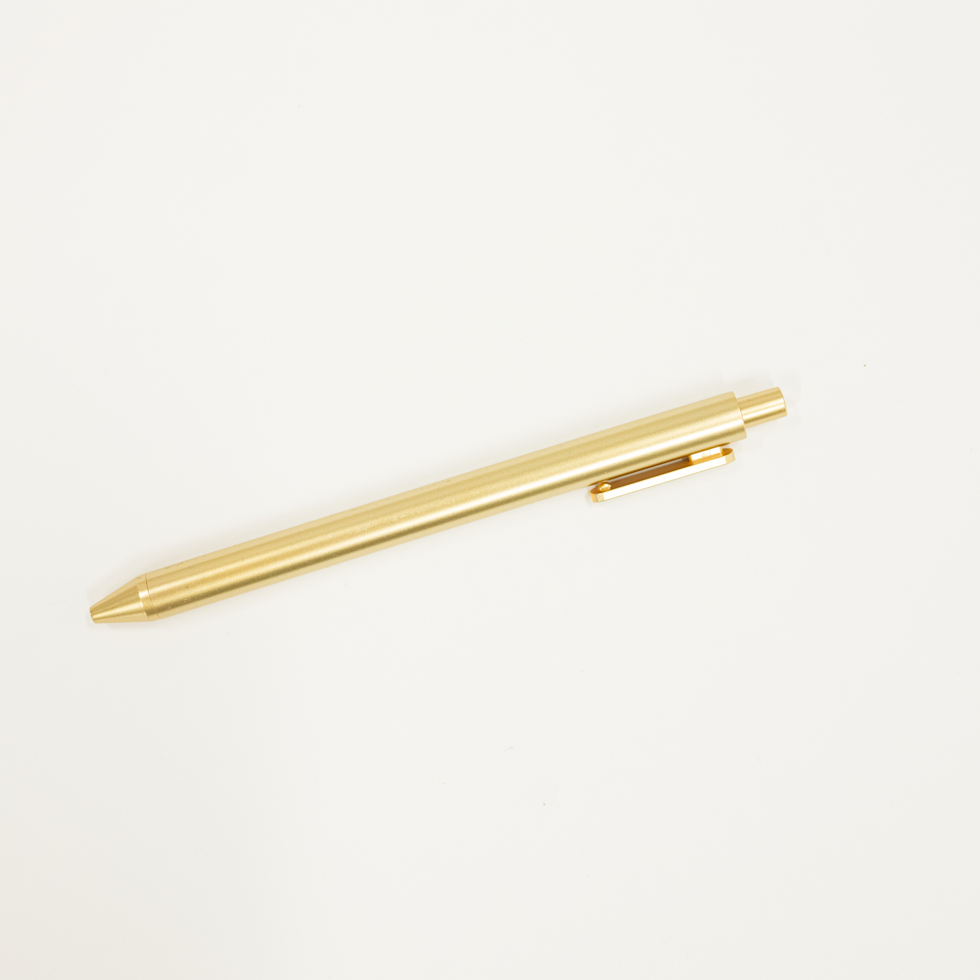 Gold pen on a white background