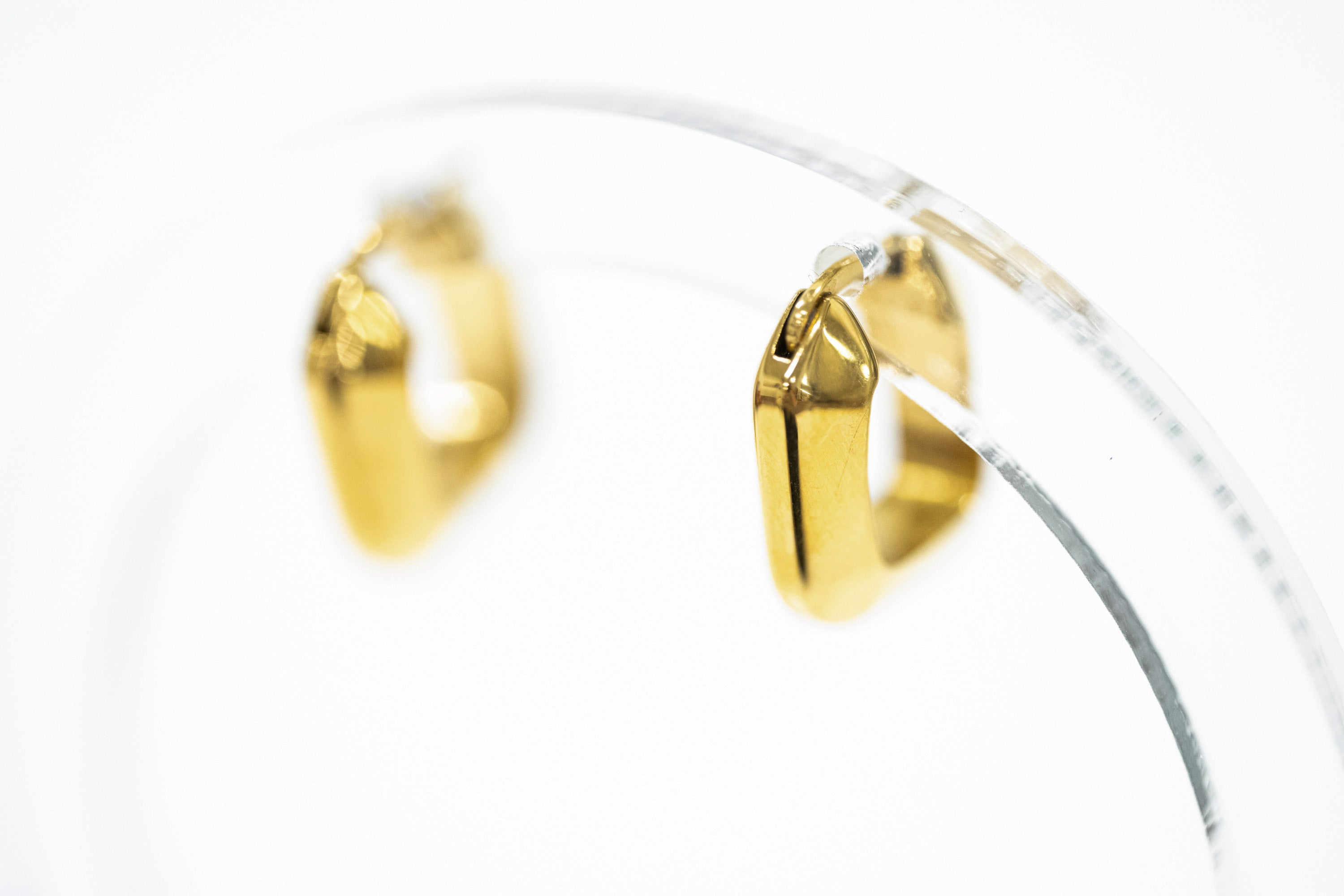 square gold hoop with clasp closure on white background