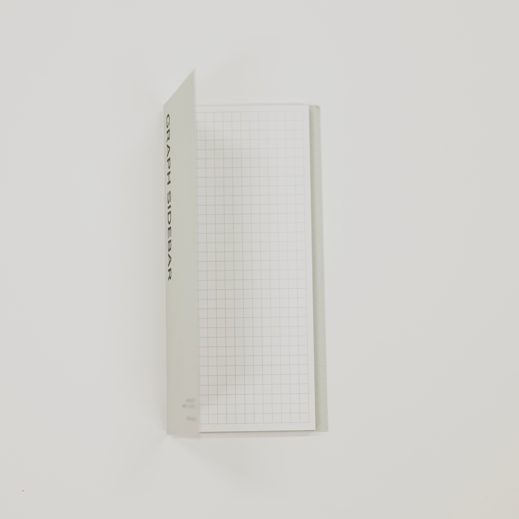 Grid-patterned sticky note with text on a white background