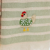 close up detail shot of an embroidered chicken with a green polka dotted sweater 