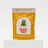Yellow package of 'Hanging Planter' DIY air dry clay kit by Breathe People on a white background