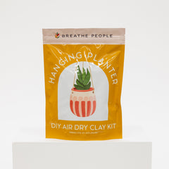 Yellow package of 'Hanging Planter' DIY air dry clay kit by Breathe People on a white background