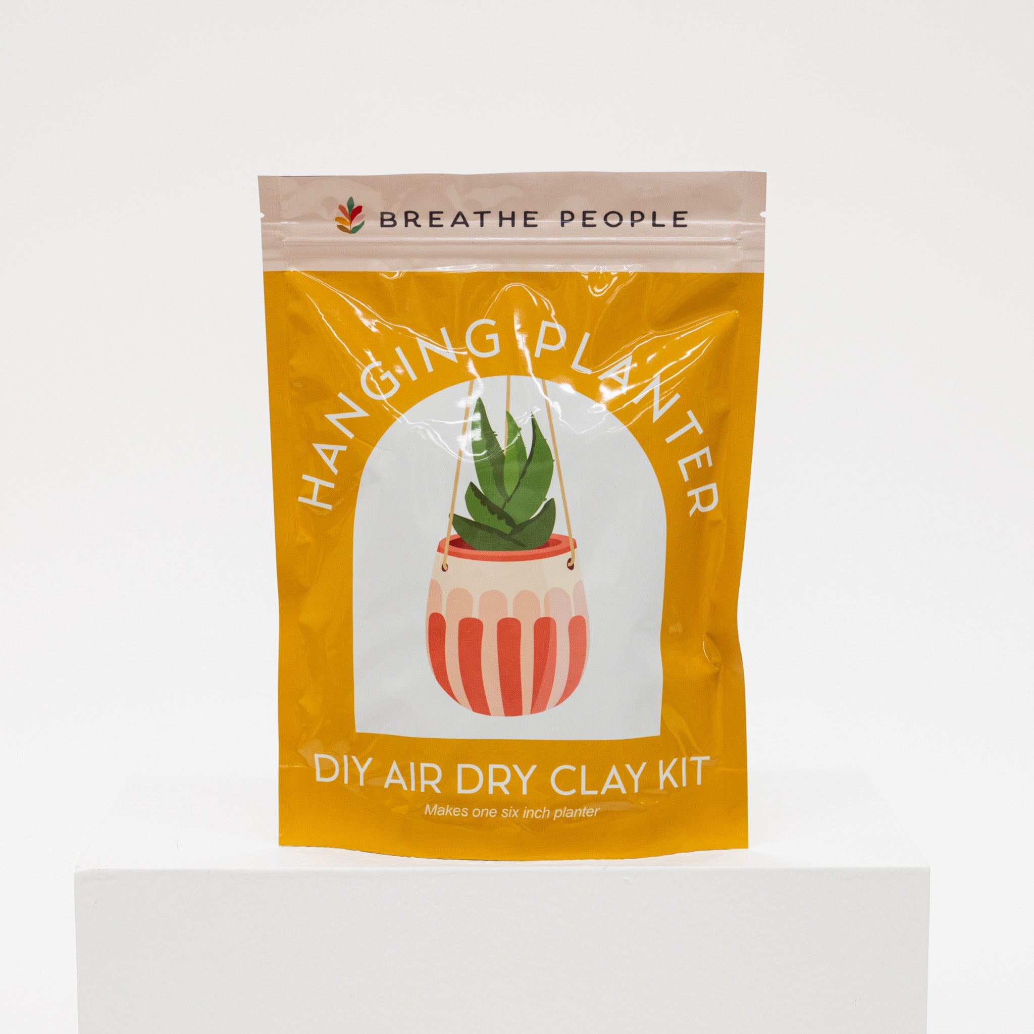 Yellow package of 'Hanging Planter' DIY air dry clay kit by Breathe People on a white background