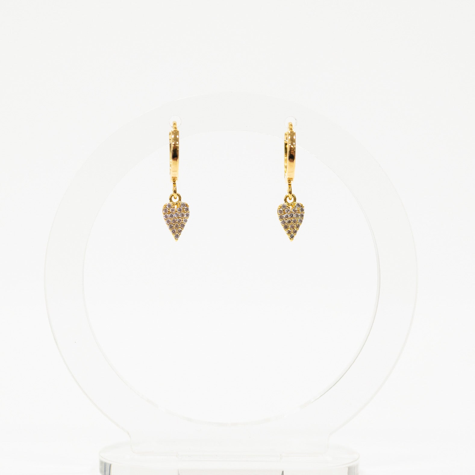 Gold heart-shaped earrings on a white background