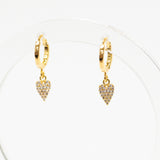Gold hoop earrings with heart-shaped charms on a white background