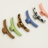 Set of colorful hair clips for kaxi midi sized claw on a light background