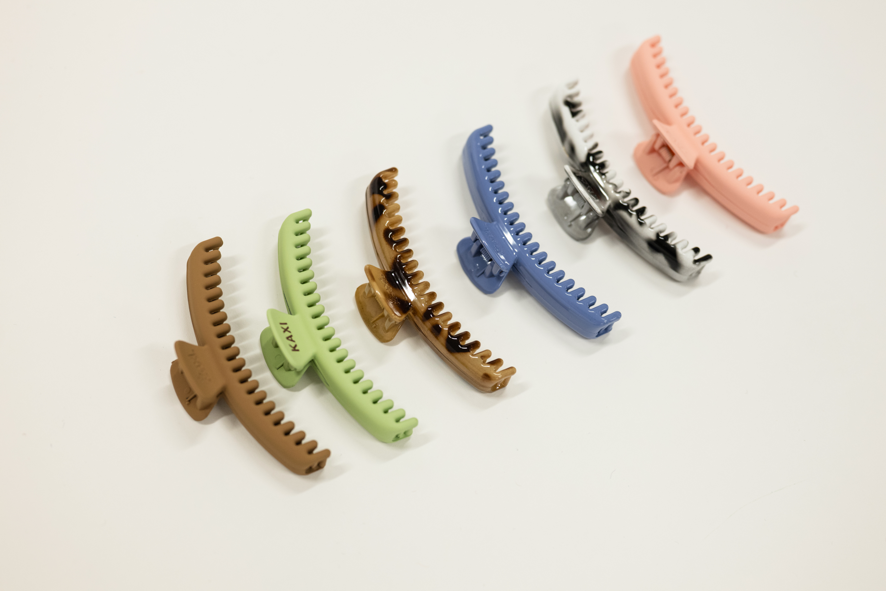 Set of colorful hair clips for kaxi midi sized claw on a light background