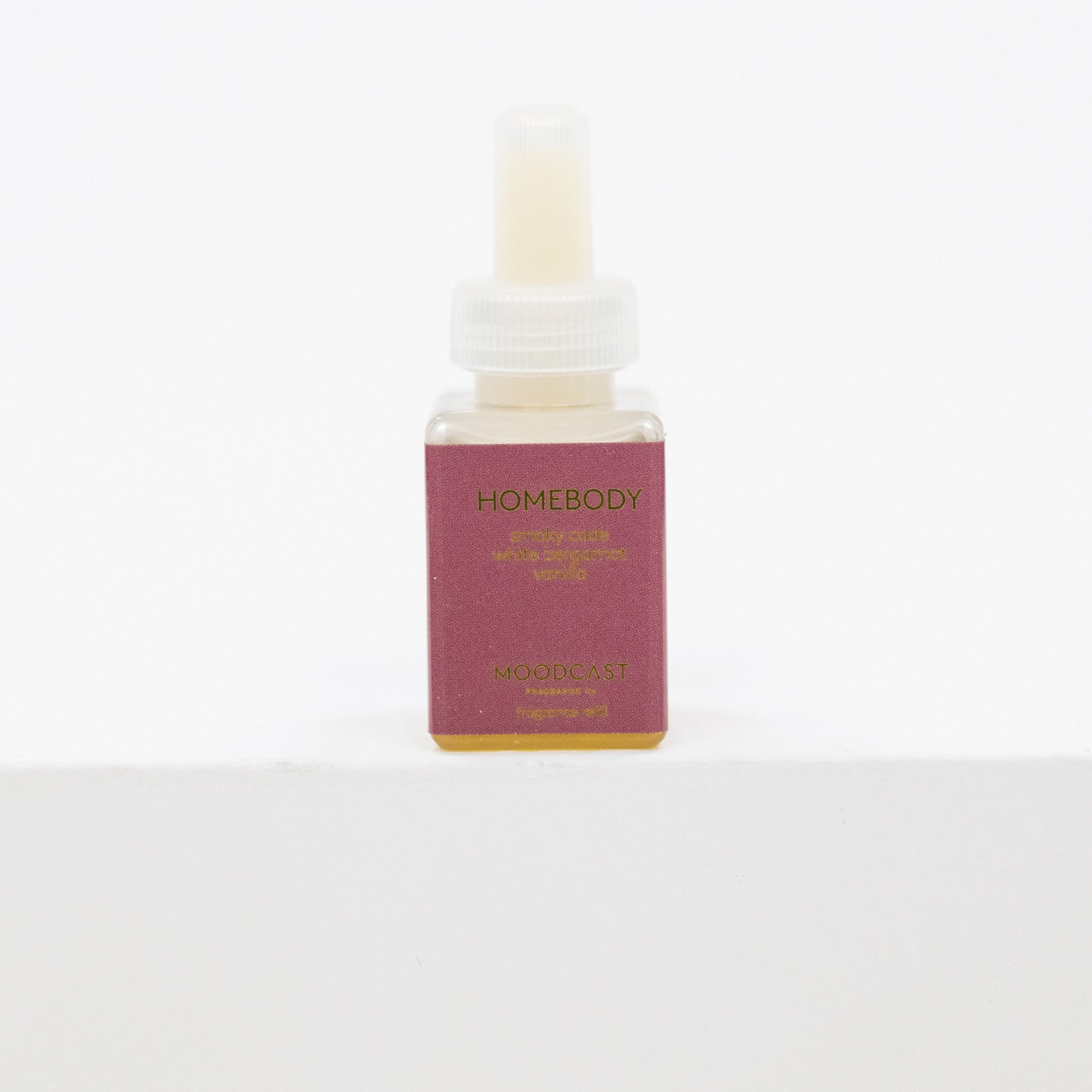 A small rectangular bottle of Moodcast Homebody Relaxing Calm oil with a dusty rose label and gold lettering, set against a plain white background.