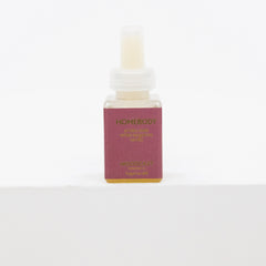 A small rectangular bottle of Moodcast Homebody Relaxing Calm oil with a dusty rose label and gold lettering, set against a plain white background.