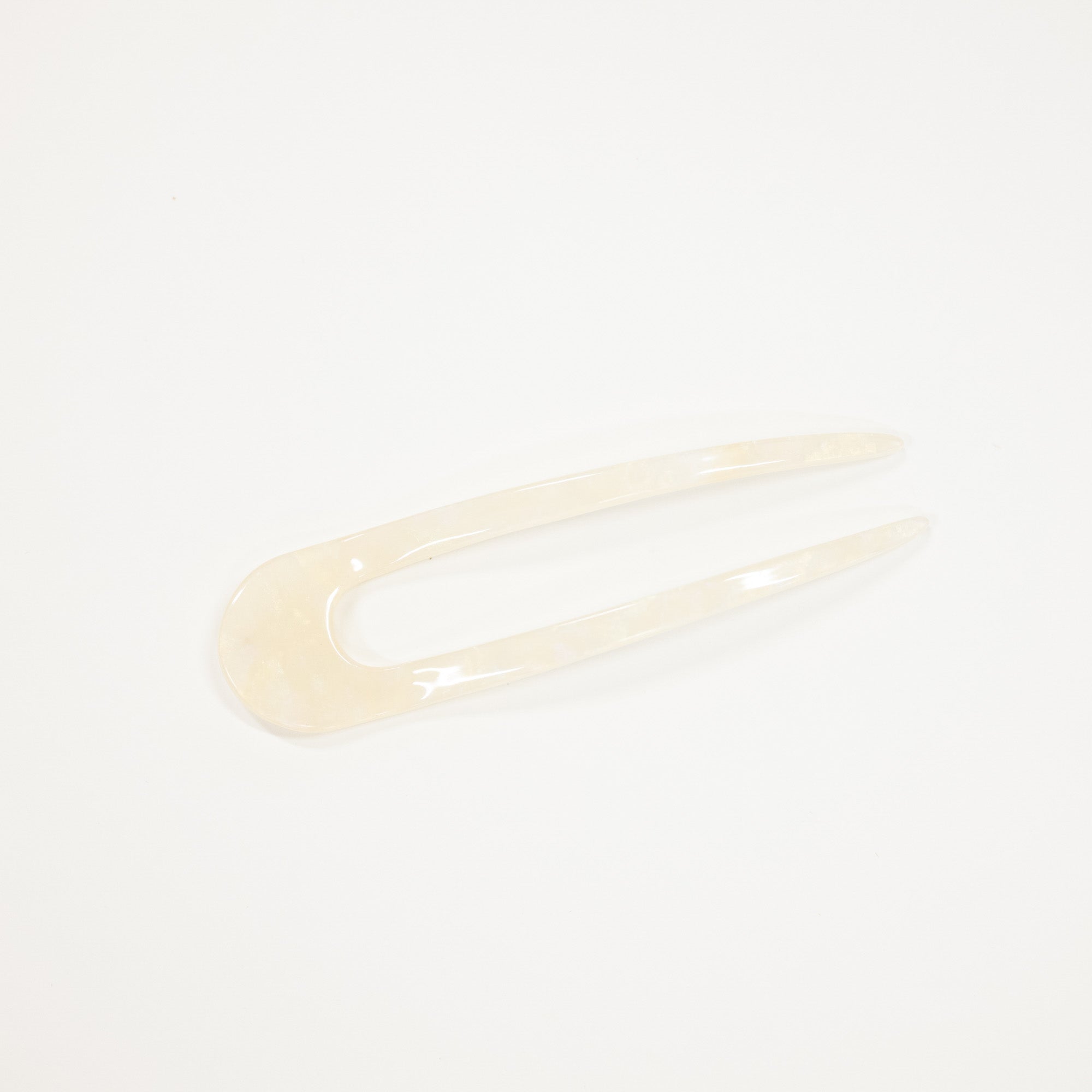 An ivory pearl finish french style hairpin.