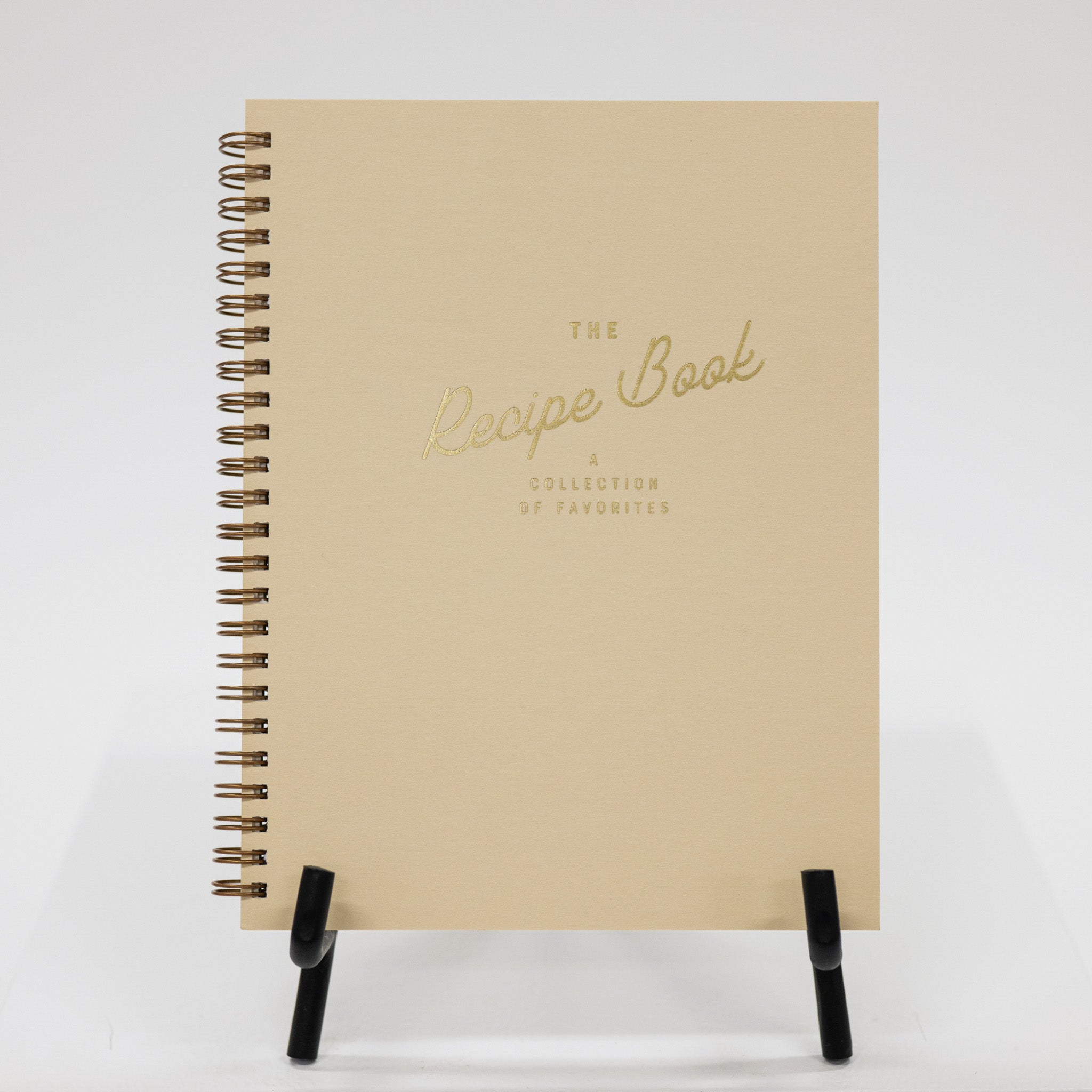 Beige recipe book with gold text on a white background