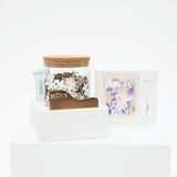 Jar of puzzle with a wooden lid on a white background