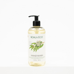 A bottle of Koala Eco Hand Wash with a black pump dispenser and a white label featuring green leaves and white flowers, set against a plain white background.