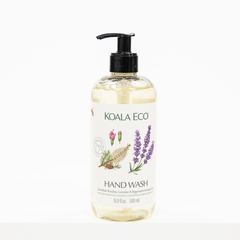 A bottle of KOALA ECO Hand Wash with a black pump dispenser and a white label featuring botanical illustrations of lavender, rose, and herbs, set against a plain white background.
