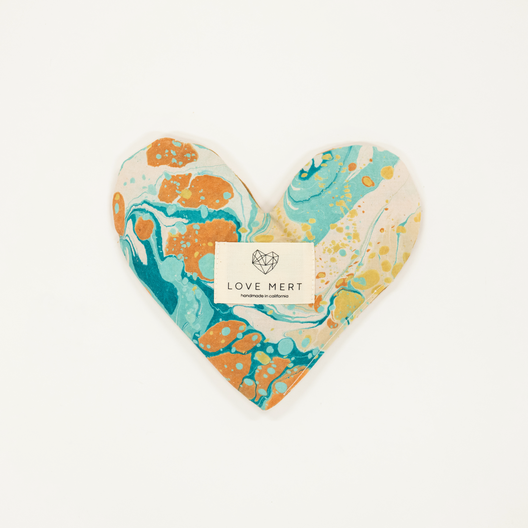 Heart-shaped decorative item with marbled design and 'LOVE MERT' label on a white background